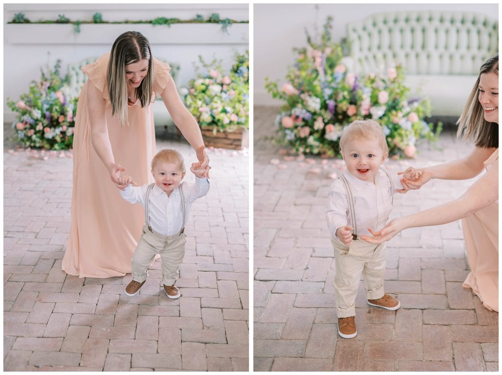 mom wearing a pink dress walking with her son