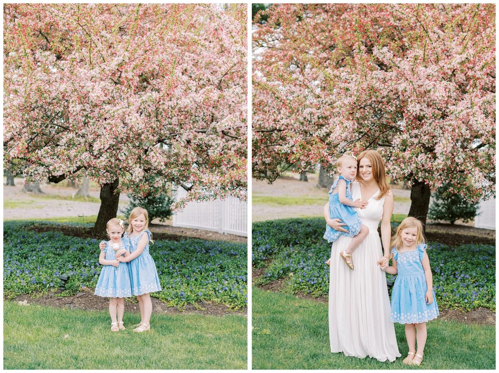 both daughters posing together in front of a pink tree