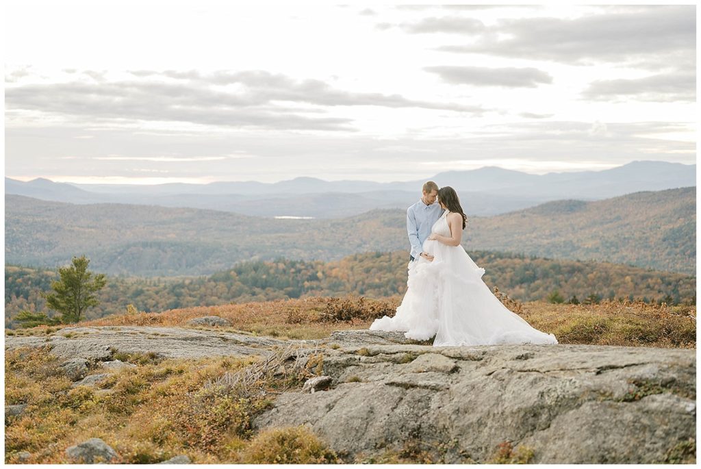 husband and wife posing together for maternity photos in New Hampshire