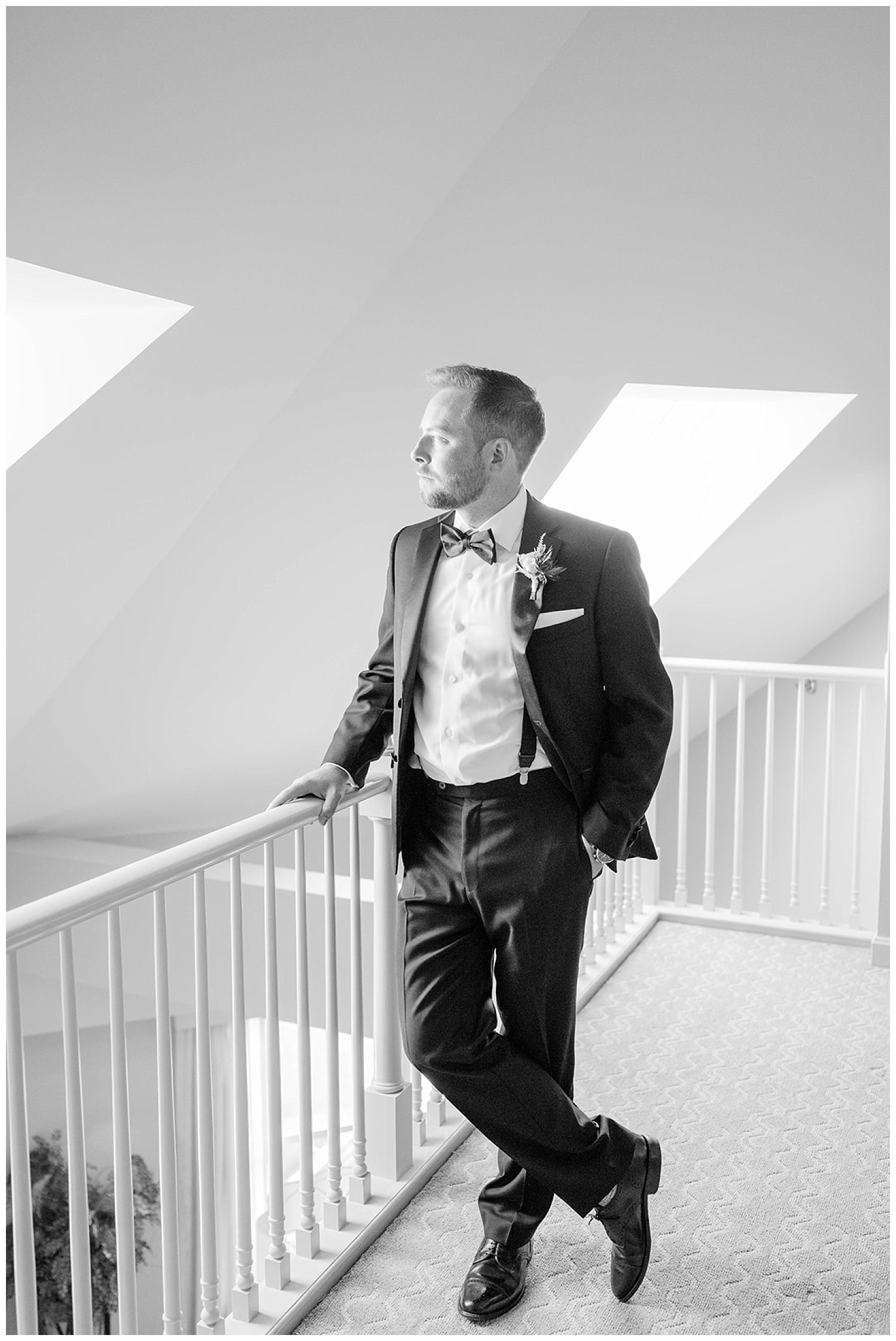 black and white photo of groom at inside balcony