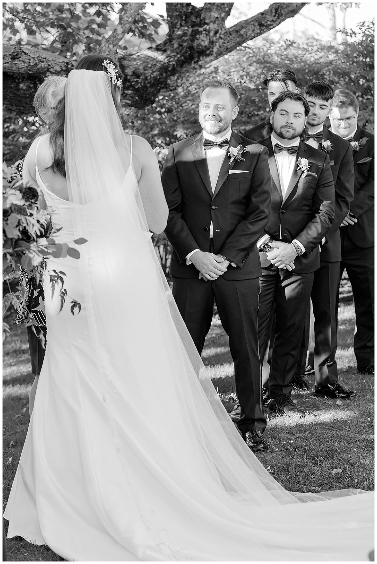 groom smiling at bride at ceremony in Maine