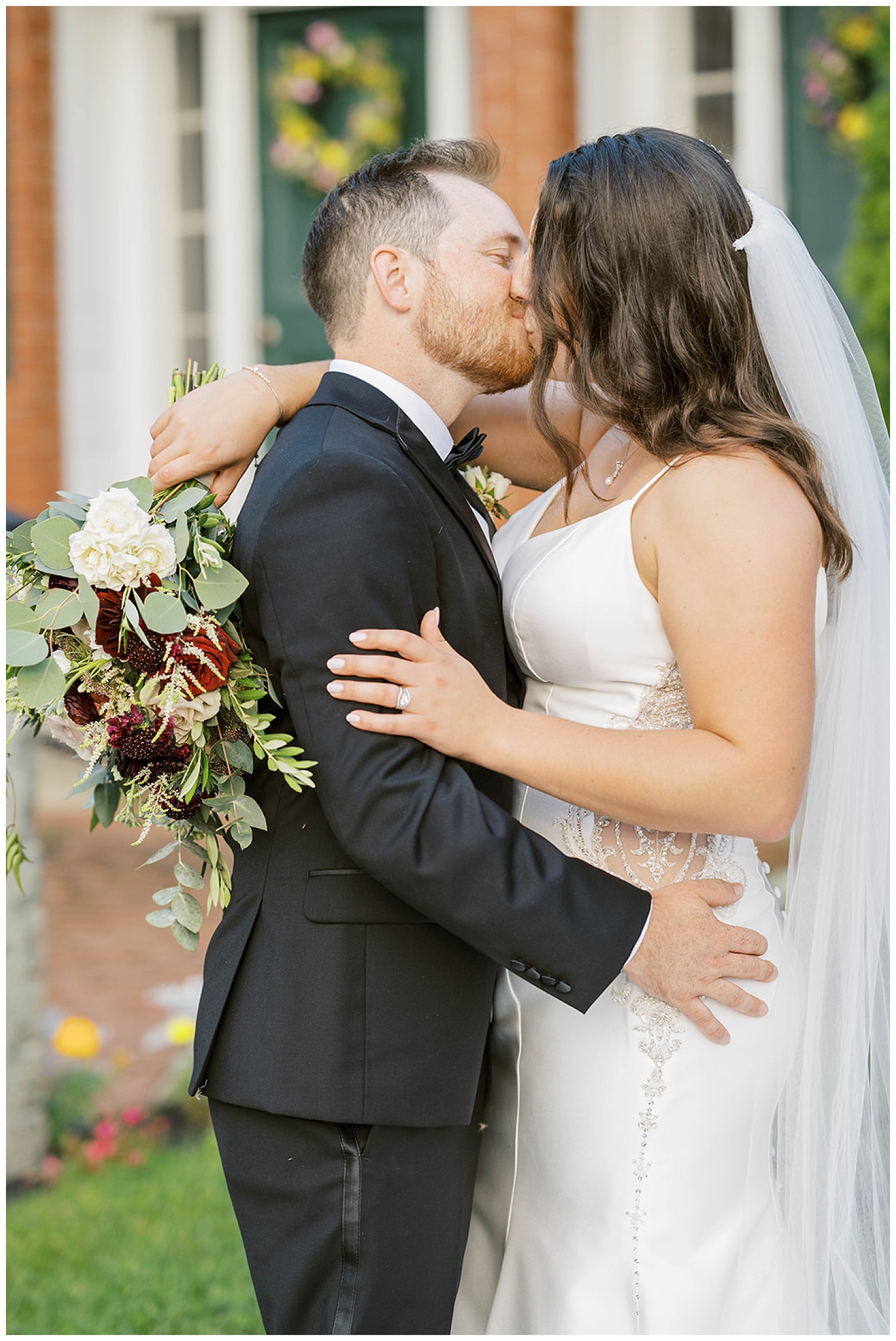 bride and groom kiss during portraits