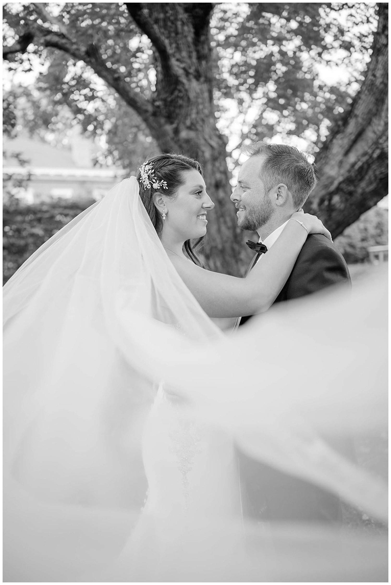 veil shot with bride and groom outside