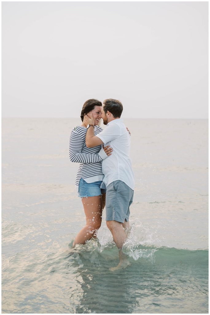 couple kissing in the waves at Mayflower Beach