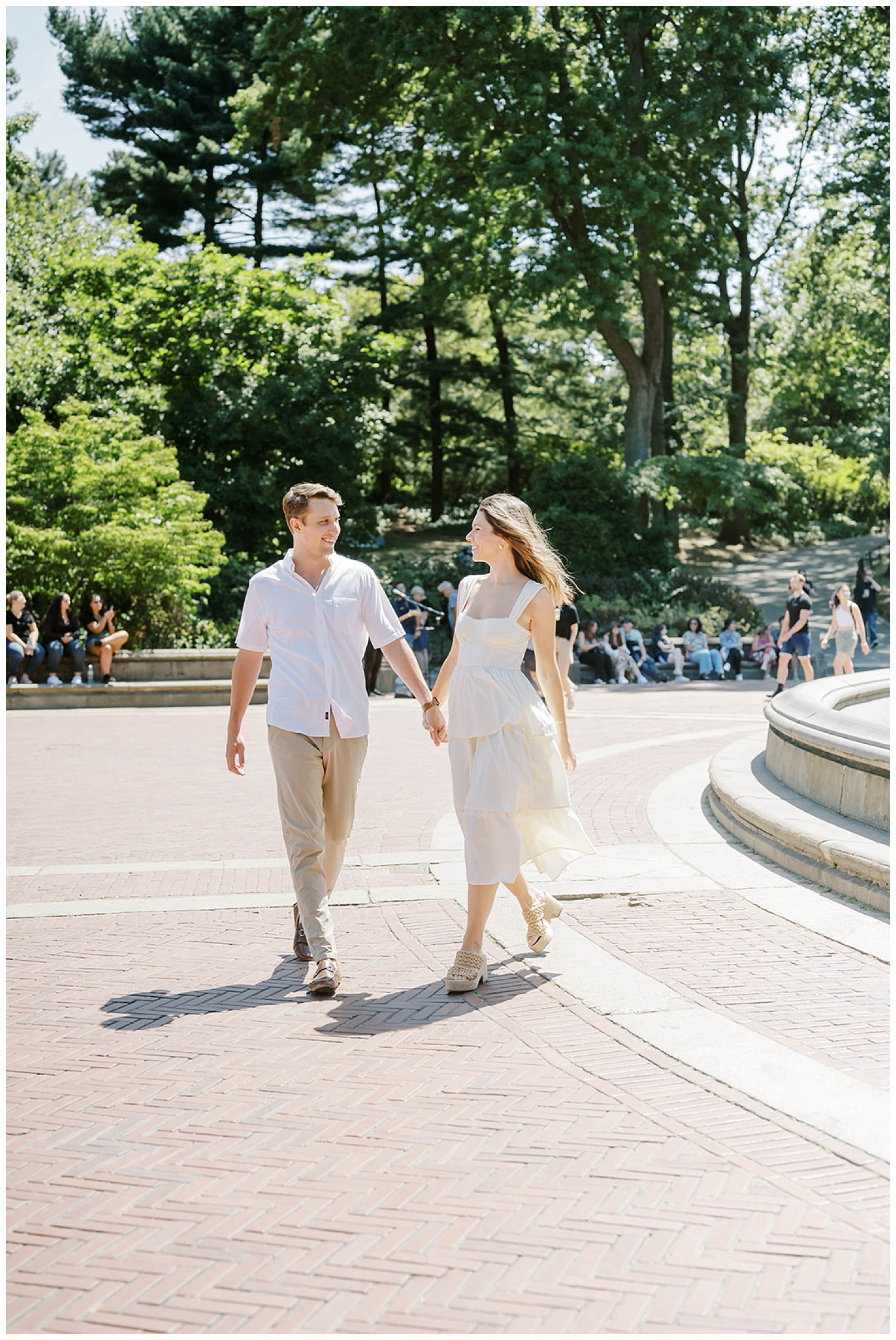 couple walking near the fountain in Central Park in New York
