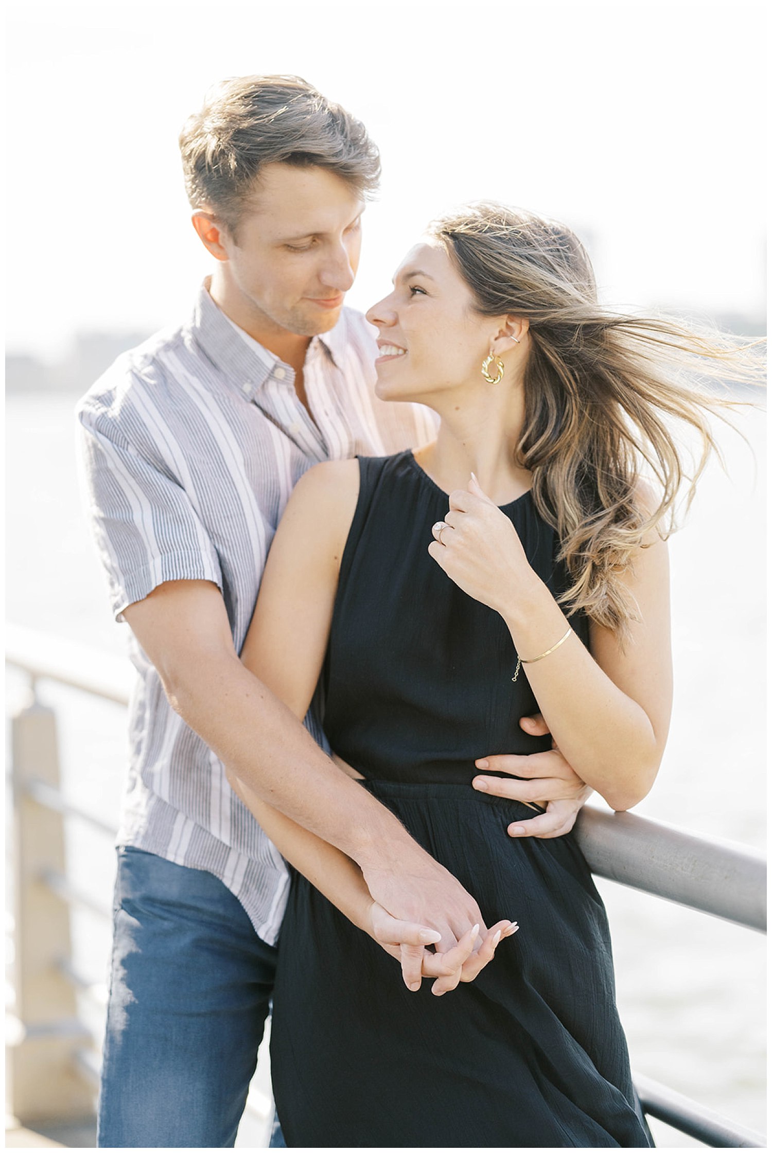 couple standing next to the Hudson River at New York City engagement session