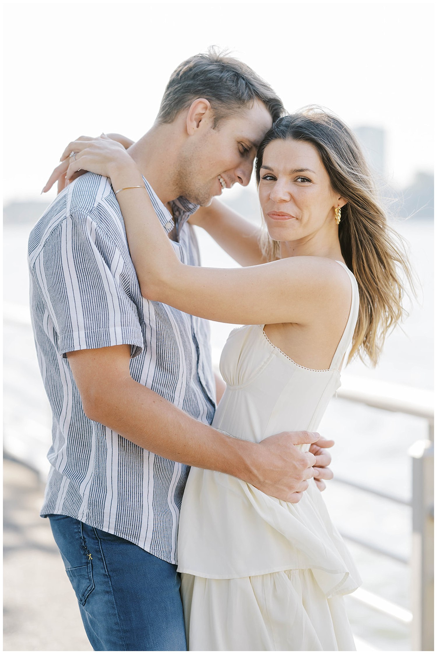 couple standing next to the Hudson River at New York City engagement session