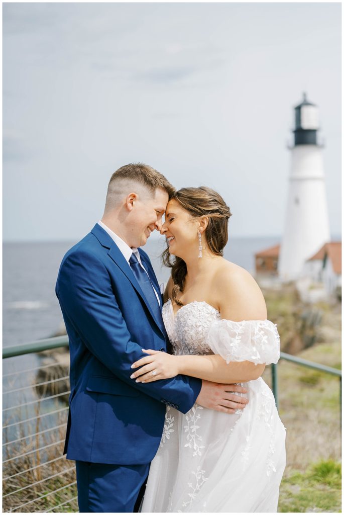 wedding couple posing for portraits at the Portland Maine lighthouse