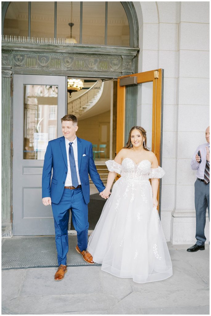 elopement couple walking out the door at Portland City Hall in Maine