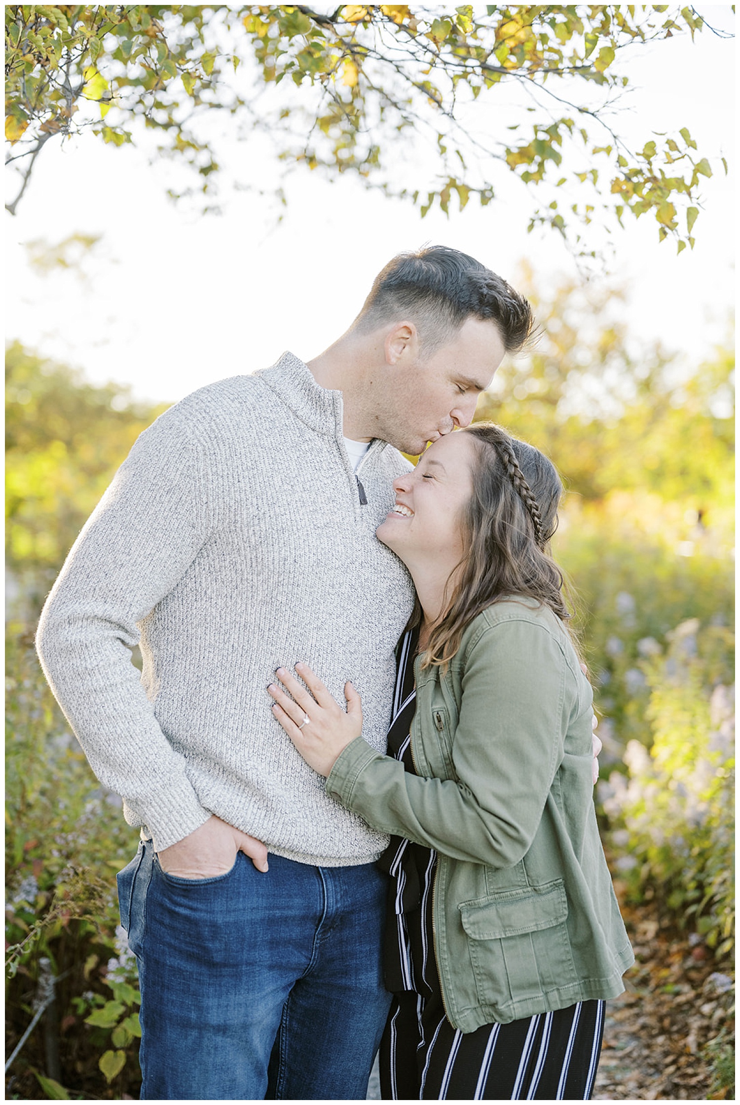 man kissing girl's forehead at Fort Williams Park engagement session