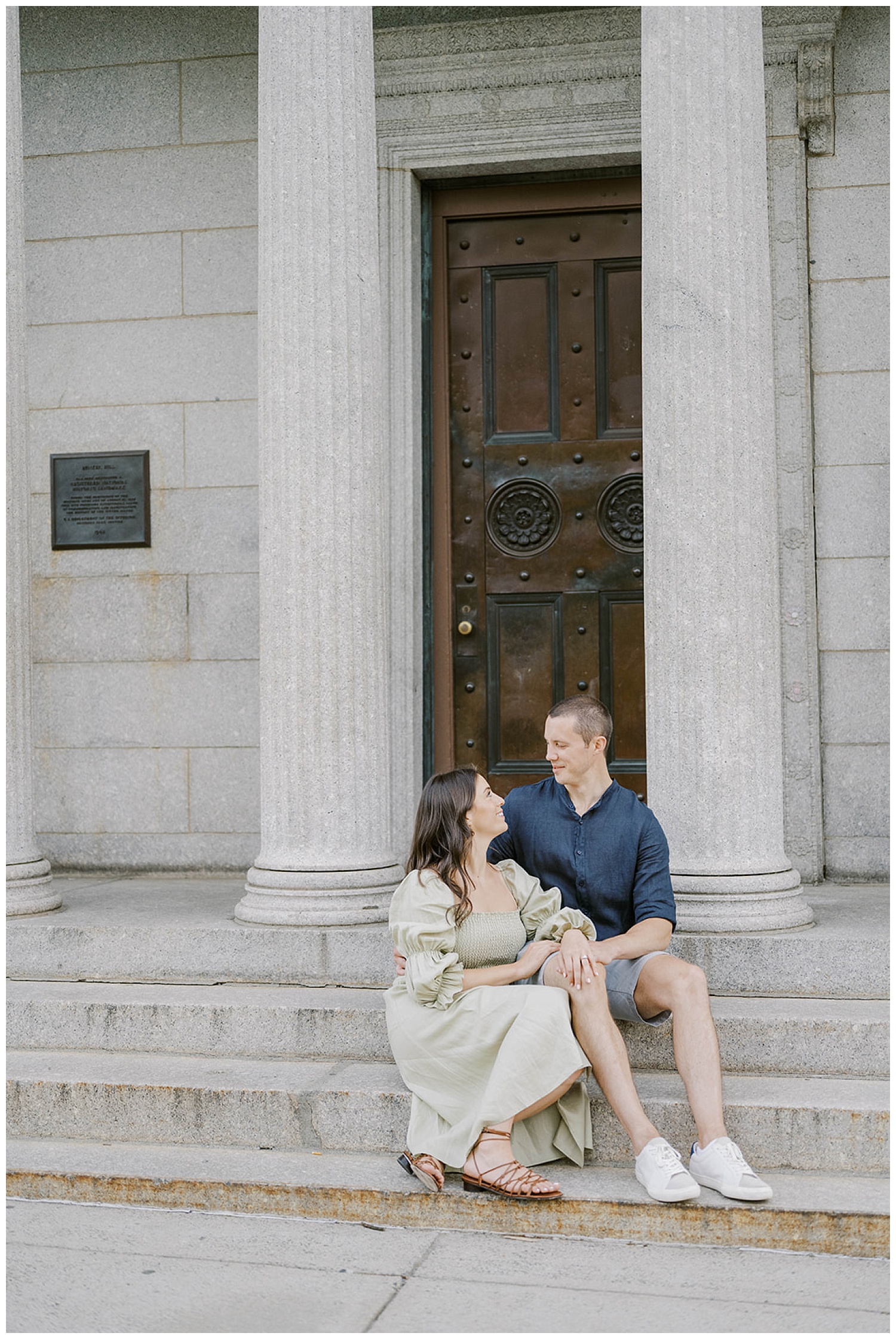 couple sitting on steps near Monument Square at Boston engagement session