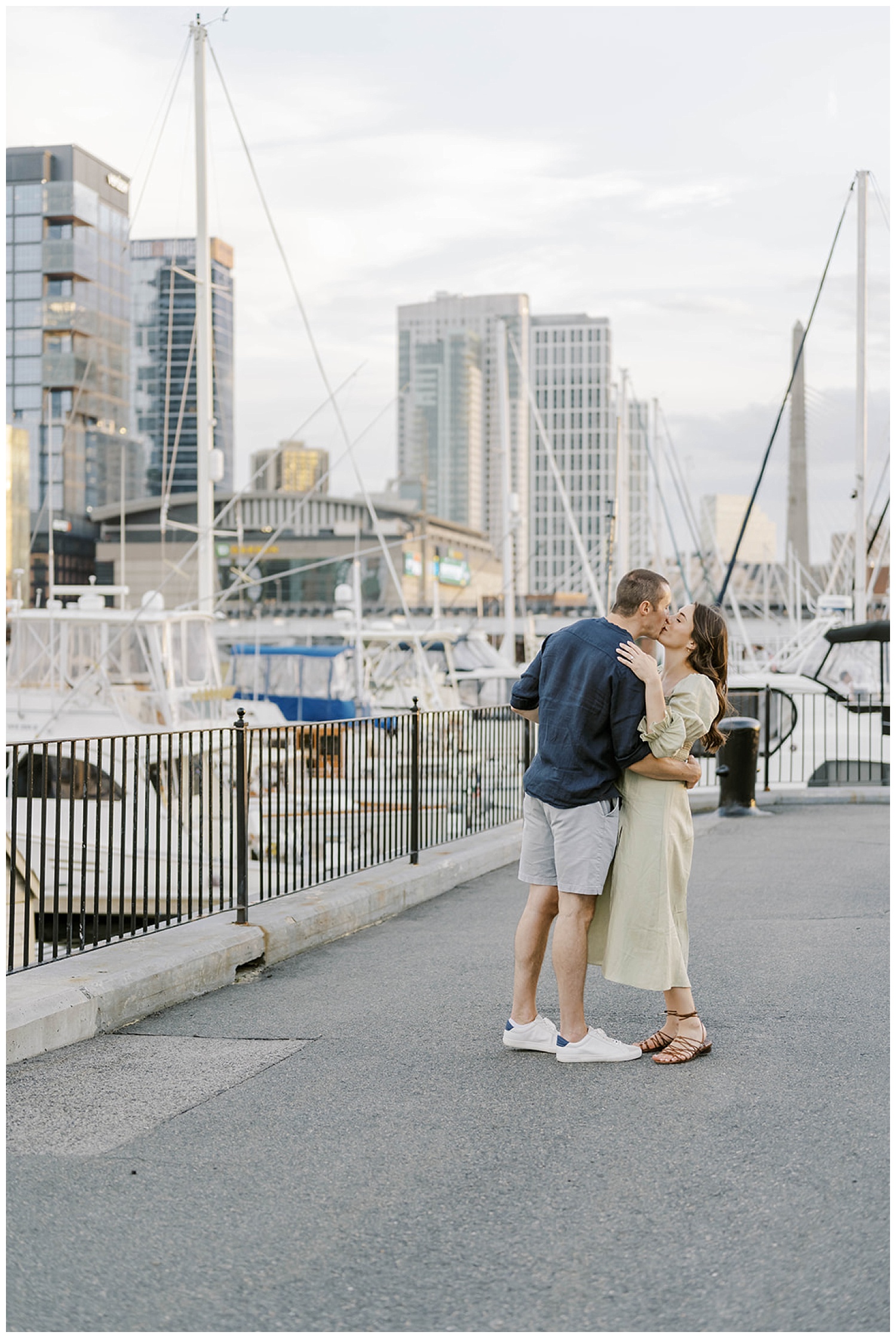 couple kissing near the water in Boston at engagement session