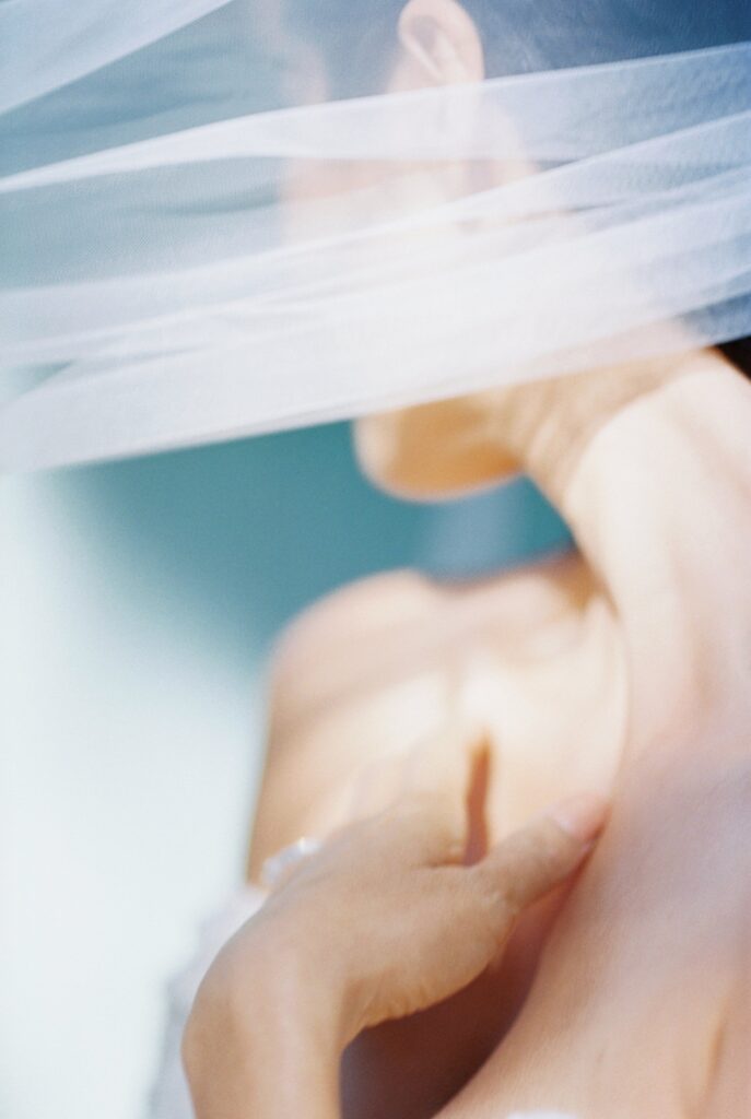 close up of bride looking away from the camera with a veil across her face