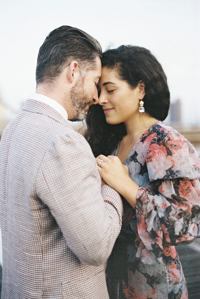 couple touch foreheads during engagement session in New York City