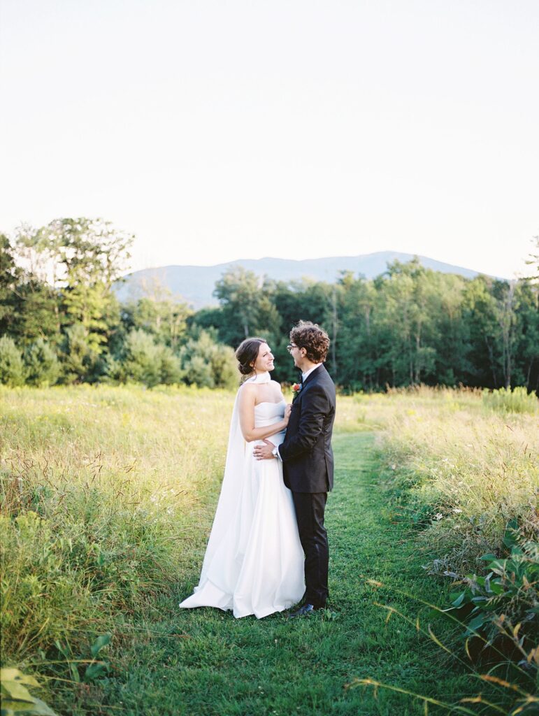 couple share a moment in a field during their wedding day