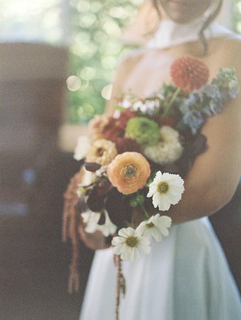 bride holds a wildflower bouquet 