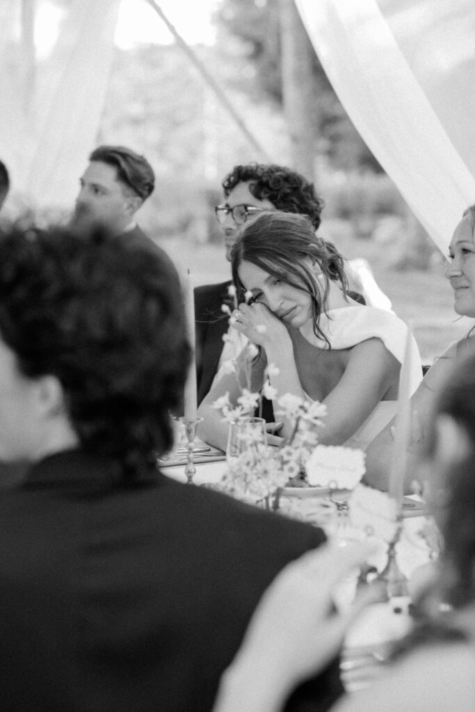 Guests raising glasses for a toast during the outdoor reception at Aldworth Manor