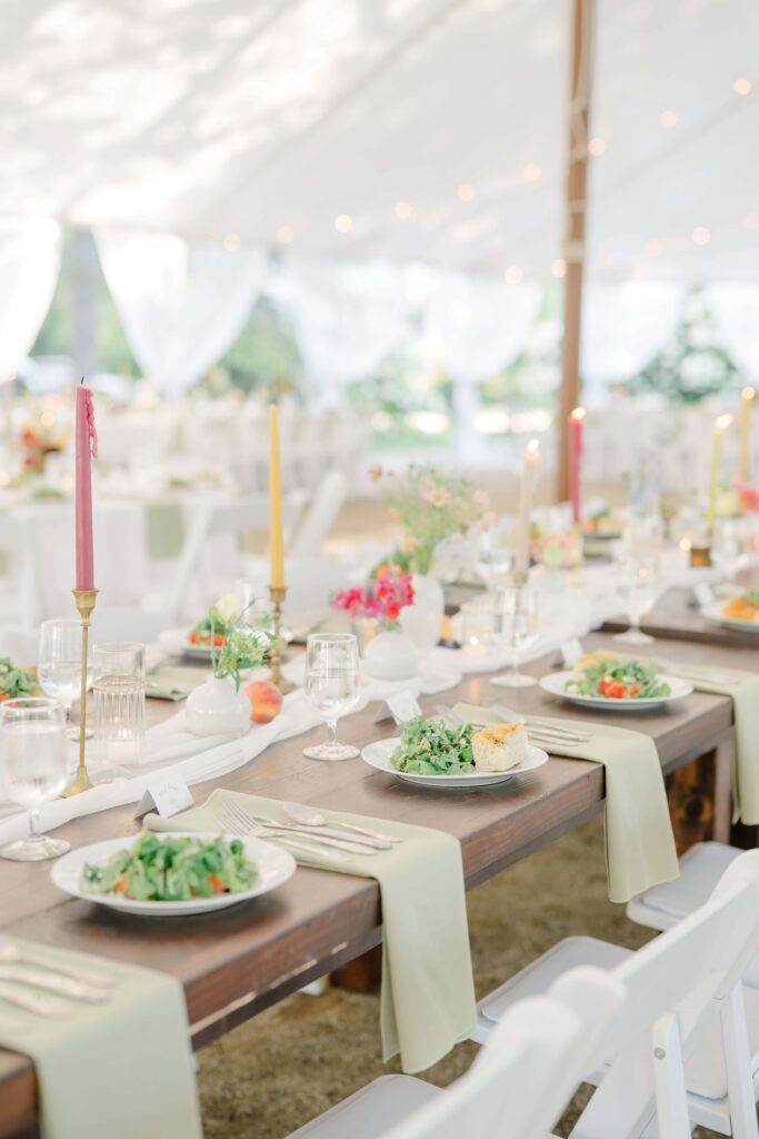 Reception tablescape with Italian-inspired floral centerpieces and soft candlelight