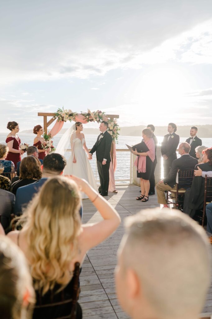 Bride and groom exchanging vows on the ocean deck at Beauport Hotel Gloucester MA