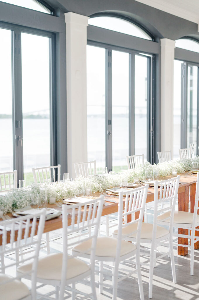 Elegant white wedding reception tablescape with baby’s breath at Belle Mer, Newport Rhode Island.