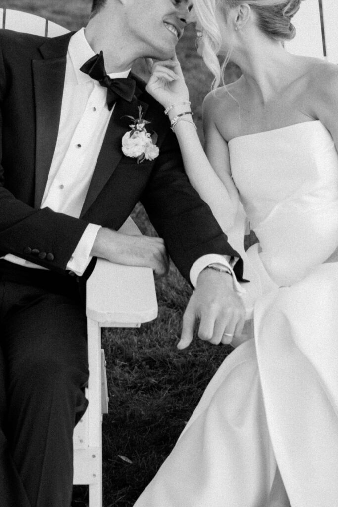 Bride and groom sharing a quiet golden hour portrait on the lawn at Eisenhower House with ocean views behind them.