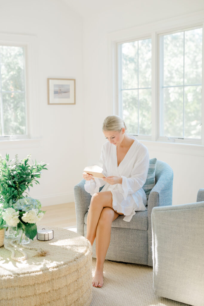 Bride reading a letter on the wedding morning at Wychmere Beach Club