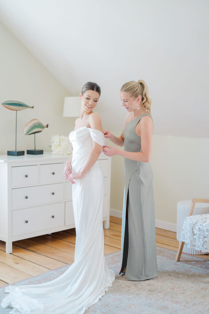 Bride smiling with her bridesmaids before the wedding at Belle Mer, Newport RI.