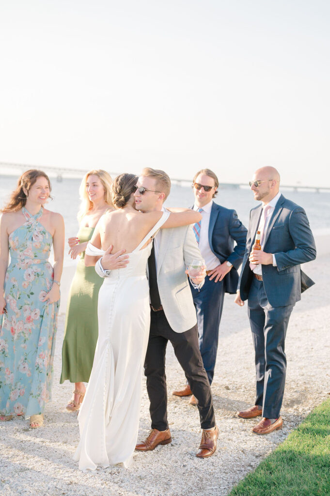 Bride greeting guests during waterfront cocktail hour at Belle Mer, Newport Rhode Island wedding.