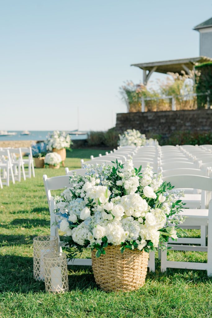 White hydrangea floral baskets lining ceremony aisle at Wychmere Beach Club