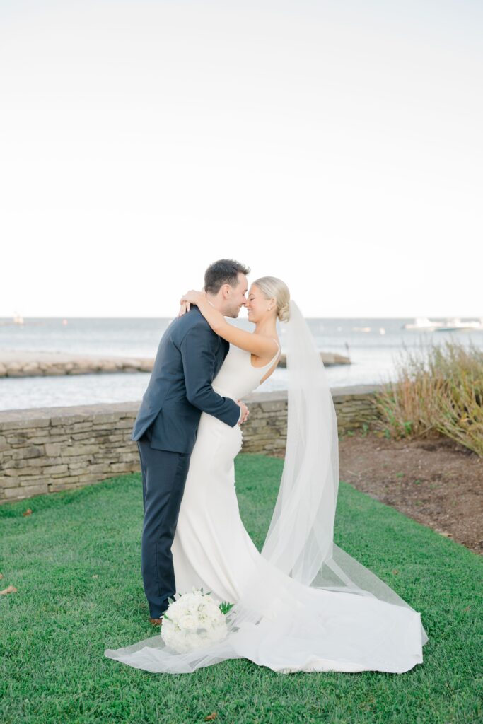 Bride and groom embracing during first look at Cape Cod wedding venue