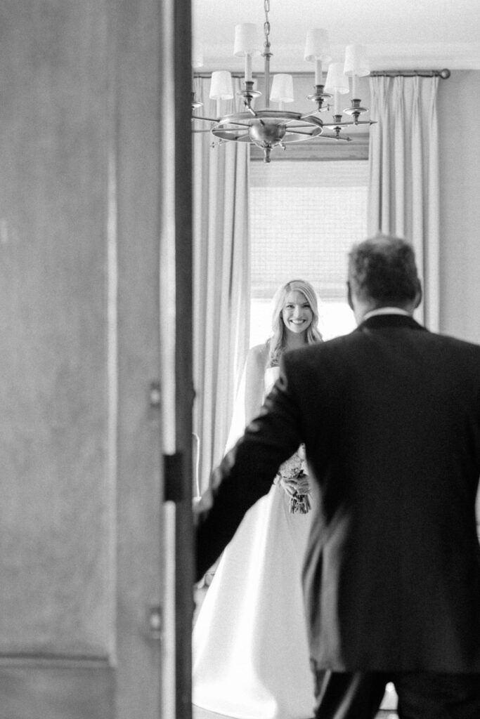 Emotional moment as the father of the bride sees his daughter for the first time in her gown.