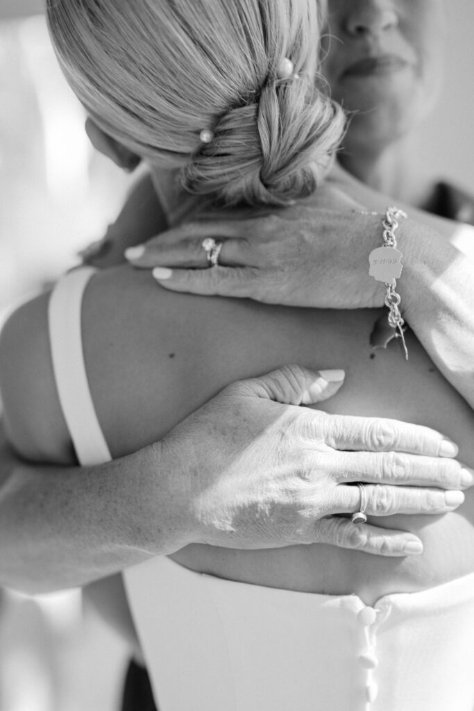 Close up of mother embracing bride during getting ready at Wychmere Beach Club