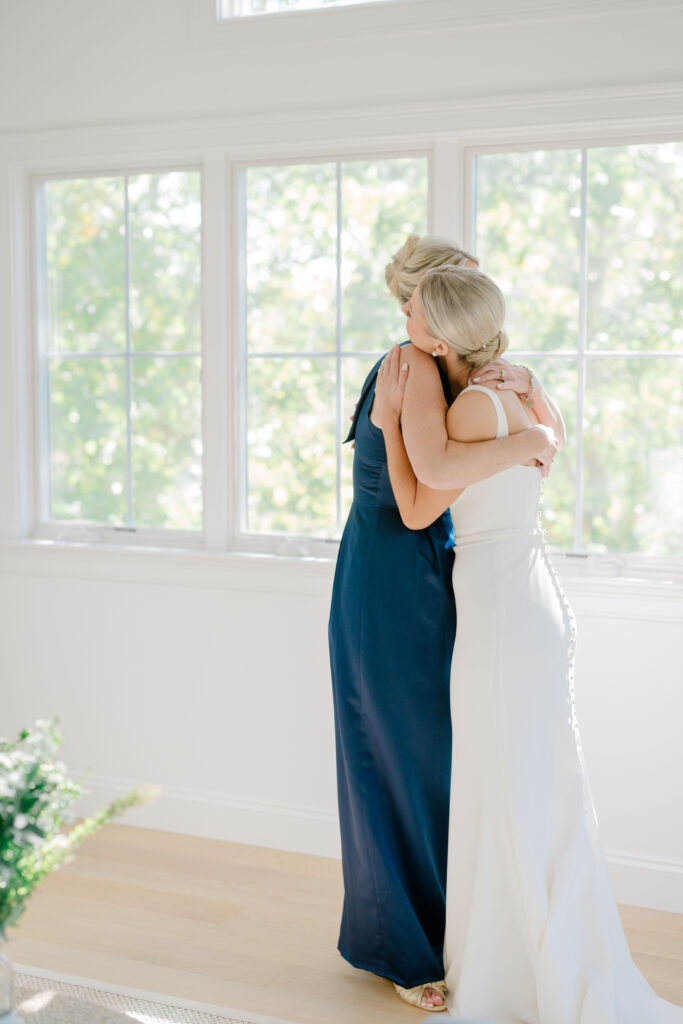 Emotional hug between bride and mother at Wychmere Beach Club wedding