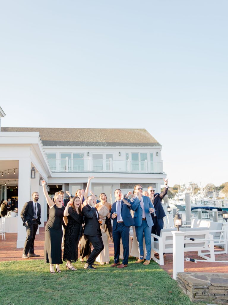 Guests cheering during cocktail hour on lawn at Wychmere Beach Club