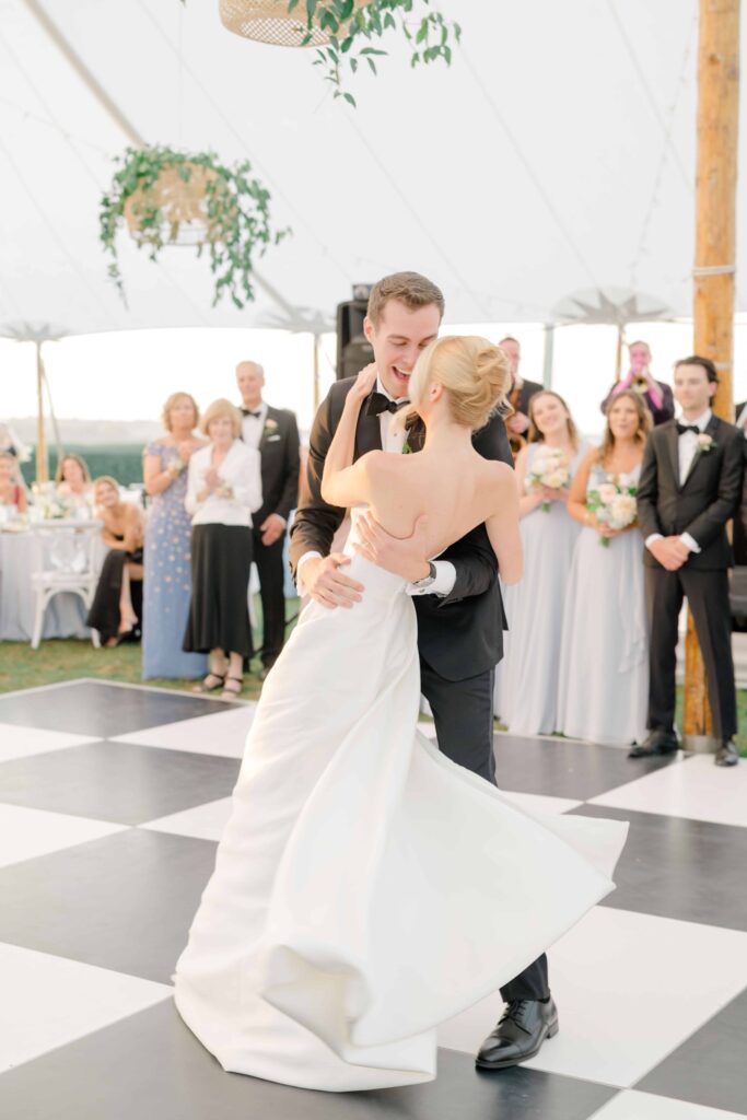 Black and white dance floor and soft draping inside coastal reception tent at Eisenhower House.