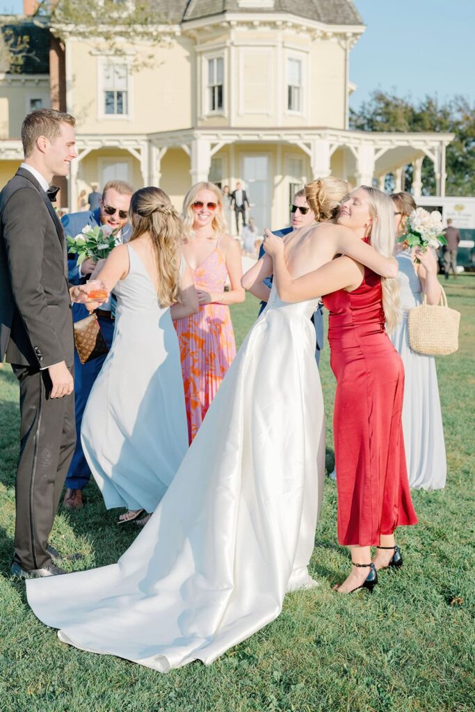 View of guests mingling during cocktail hour overlooking Narragansett Bay at Eisenhower House.