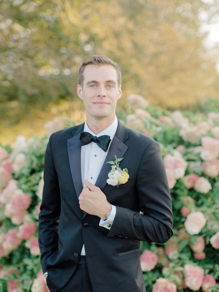Detail of groom’s boutonniere with pastel florals, styled for a classic Newport coastal wedding.