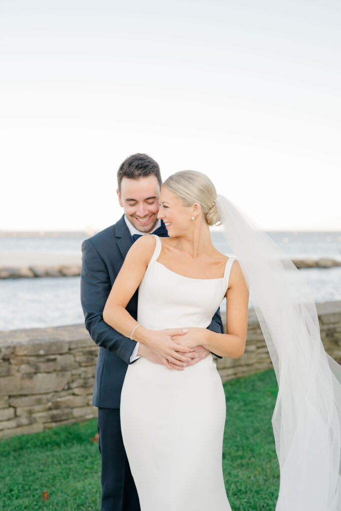 Romantic bride and groom portrait on Wychmere Beach Club waterfront lawn
