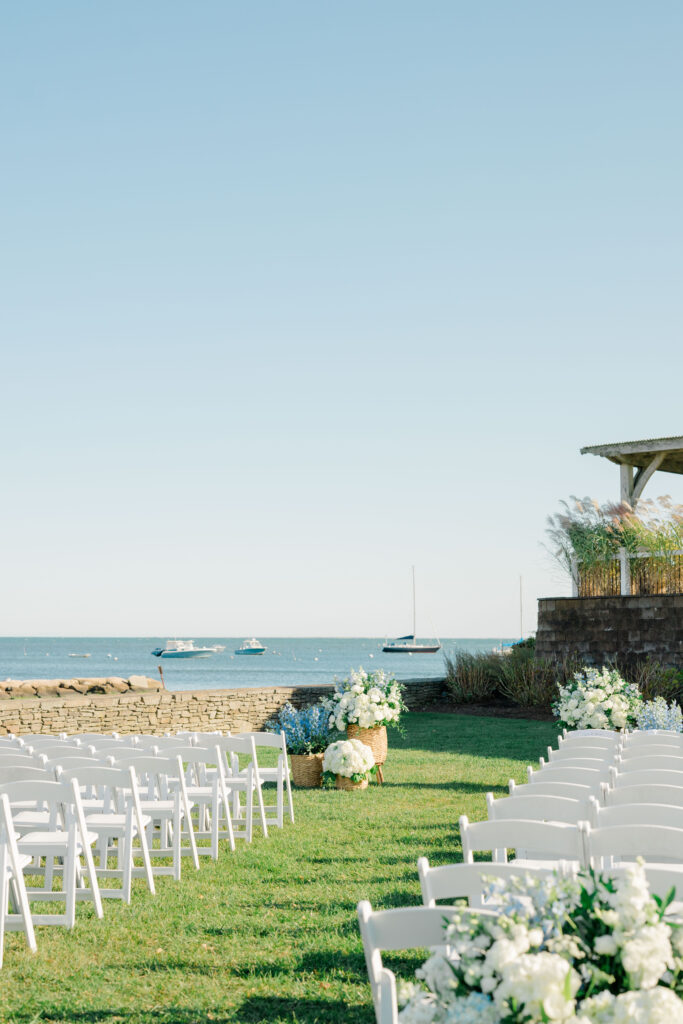 Wychmere Beach Club ceremony setup with white chairs and harbor view