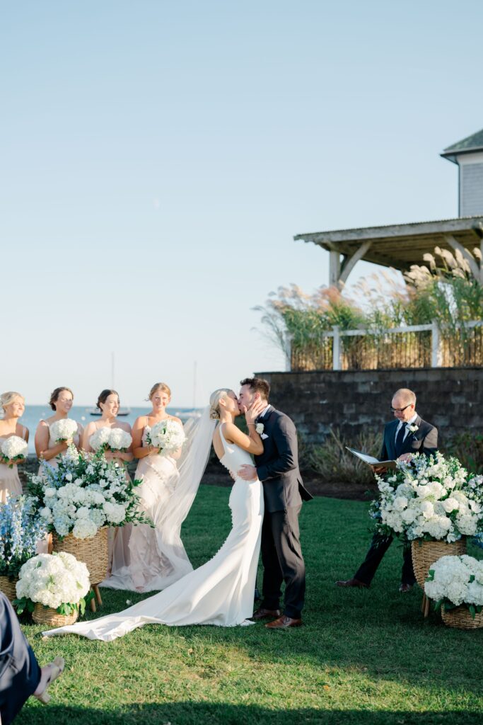 Bride and groom walking back down the aisle, guests cheering at Cape Cod wedding