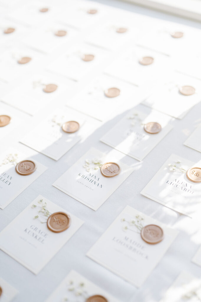 Modern wedding name cards with wax seals displayed at Belle Mer wedding reception.