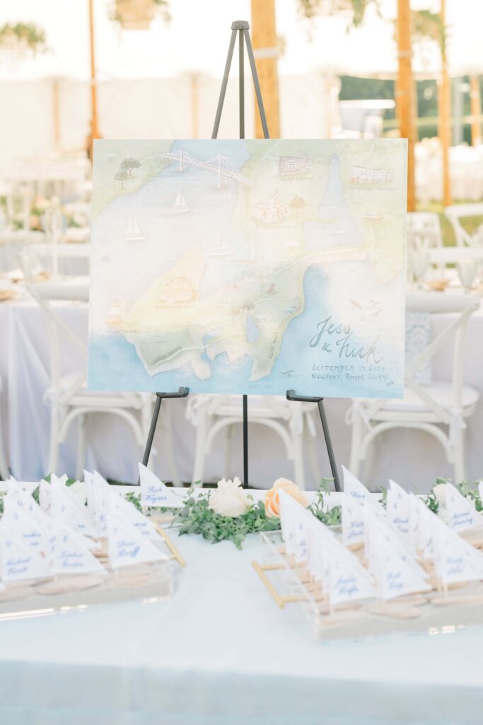 Personalized sailboat escort cards displayed during coastal cocktail hour at Eisenhower House.