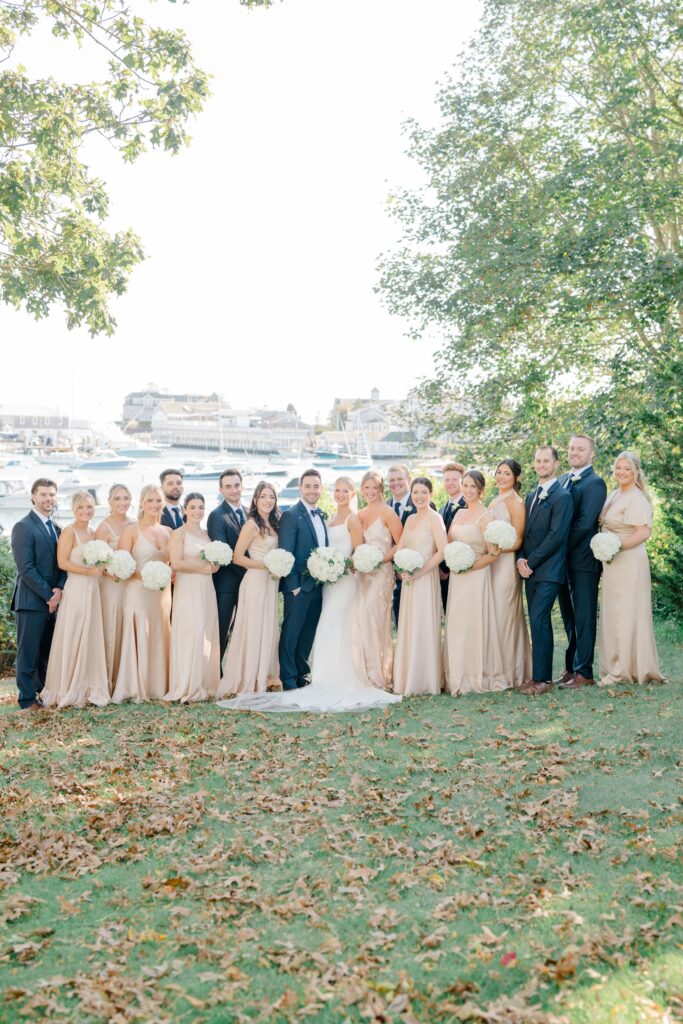 Full wedding party portrait at Wychmere Beach Club with waterfront backdrop