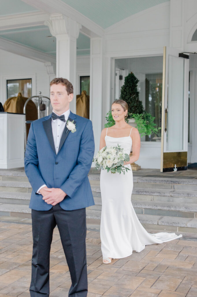 Romantic first look between bride and groom on the steps of Wentworth by the Sea Country Club.