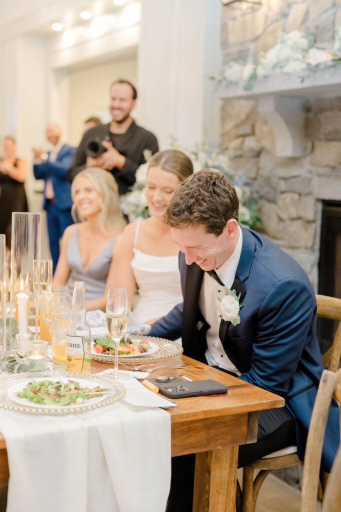 Bride and groom laughing together during speeches at Wentworth by the Sea wedding reception.