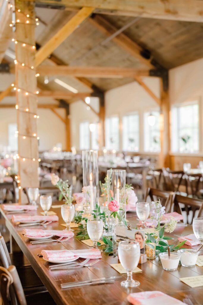 Elegant reception barn setup with candles and greenery at Mountain Top Resort.