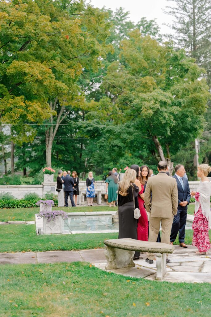 Guests standing in support during a Vermont wedding ceremony as the couple exchanges vows.