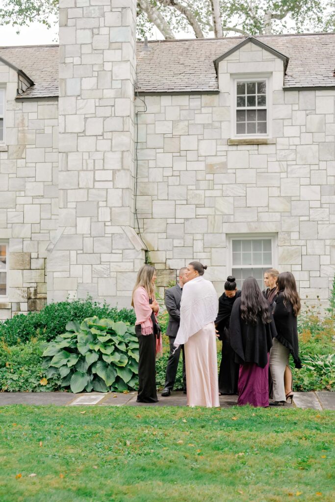 Wedding guests mingling and connecting outdoors during a Vermont wedding ceremony celebration.