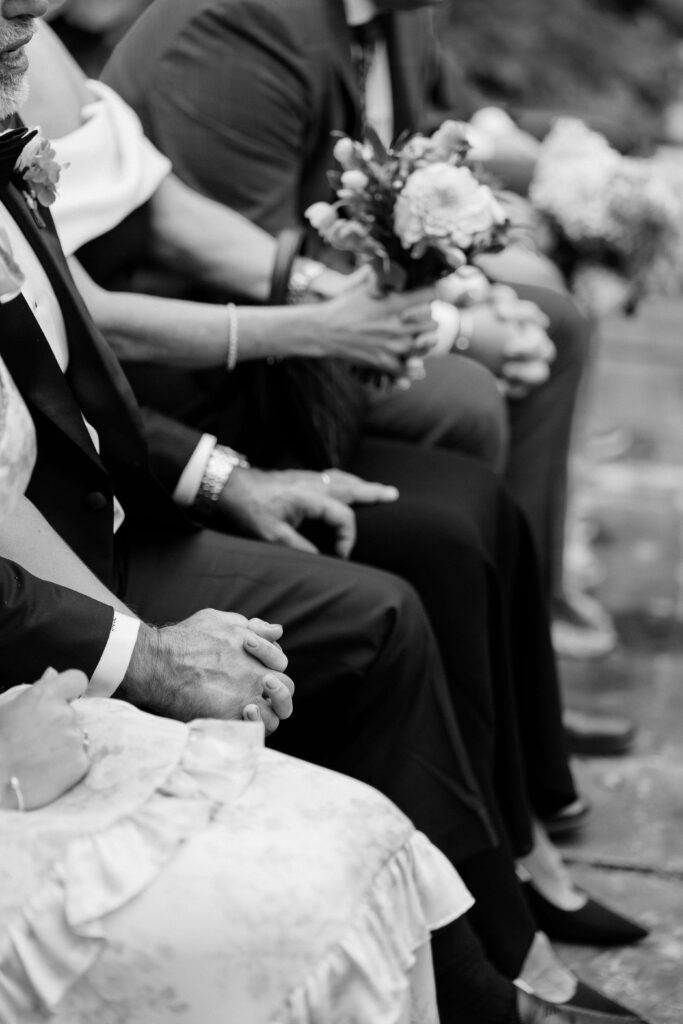 Parents watching their children exchange vows during a Vermont wedding ceremony, filled with emotion and pride.