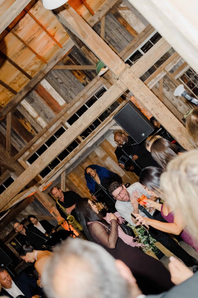 Late-night moments during a Vermont wedding reception, capturing laughter, movement, and connection.